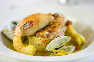 Shrimp and clam seafood appetizer on a white plate.