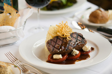 Steak dinner on white plate.