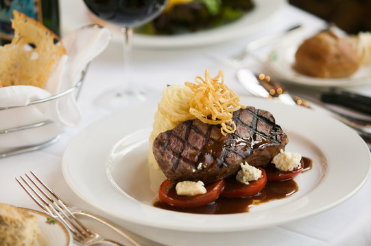 Steak Dinner On White Plate.