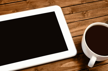 Fototapeta na wymiar Tablet with cup of coffee