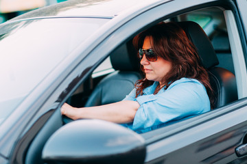 Fototapeta na wymiar Beautiful woman driving her car