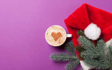 Obraz na płótnie Canvas Cup of coffee and fir-tree branch with Santas