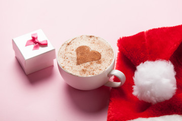 Obraz na płótnie Canvas Cup of coffee with heart shape and christmas gift