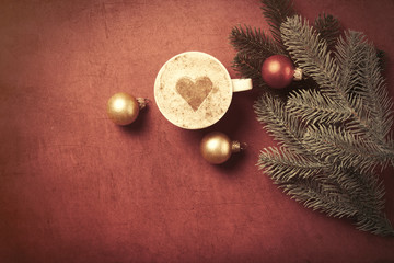 Cup of coffee with heart shape and branch