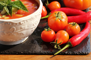 Fresh tomato gazpacho on black background