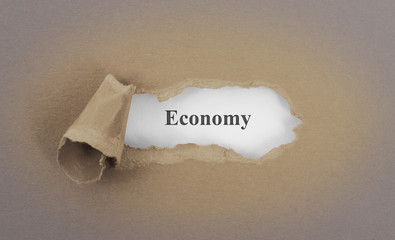 Text appearing behind torn brown envelop