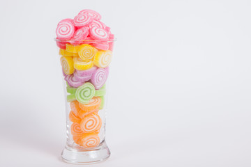 Jelly sweet, flavor fruit, candy dessert colorful in glass on wh