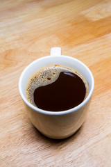 Cup of coffee on wooden table.