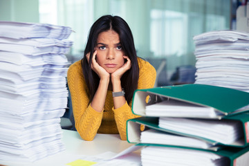 Tired businesswoman sitting at the table in office