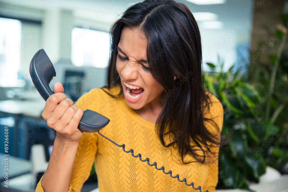 Wall mural angry businesswoman shouting on phone