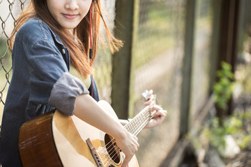 Beautiful girl playing to guitar.