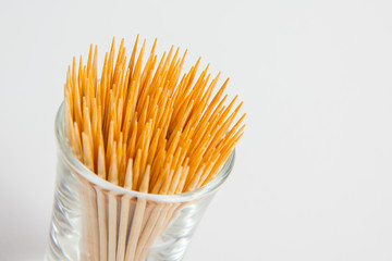 Toothpick in the glass on white paper background