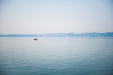 Boat on a lake in haze morning
