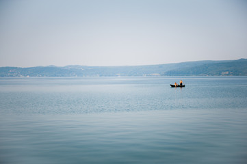 Fototapeta na wymiar Boat on a lake in haze morning