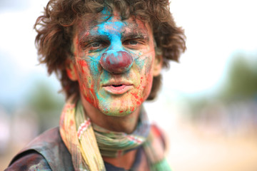 Closeup of a clown face with splattered paint on it