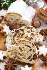 Fototapeta na wymiar Christmas Stollen with dried fruit, assorted cookies and spices