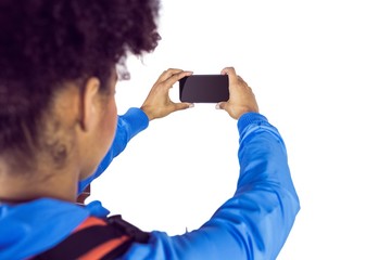 Young woman with backpack taking picture 