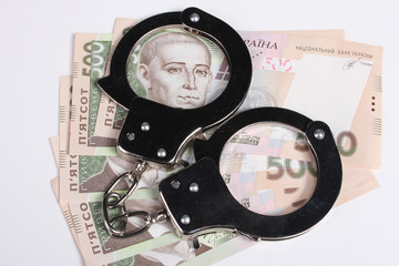 Concept - corruption. Giving a bribe. Money in hand. Handcuffs