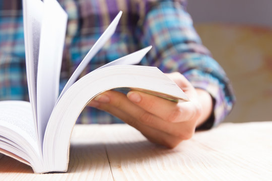 Closeup hand open book for reading concept background