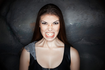 Portrait girl with grimace of anger on his face.