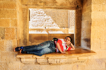Young tourist, Bengali boy resting inside the museum of Golden F
