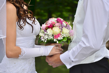 Wedding couple with wonderful bouquet in their hands