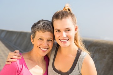 Fototapeta na wymiar Sporty mother and daughter smiling