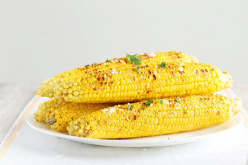 Fresh tasty grilled corn on white plate