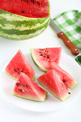 Tasty slice of watermelon on white wooden background