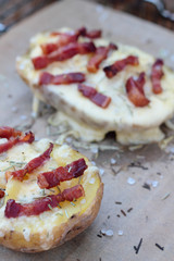 Closeup of cheese and bacon baked potatoes.