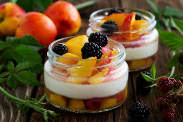 Summer dessert of peaches and yogurt with blackberries.
