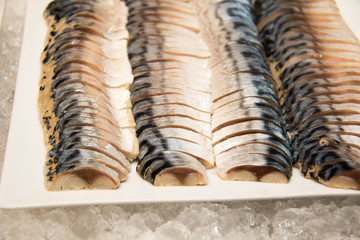  Saba fish on a white plate.