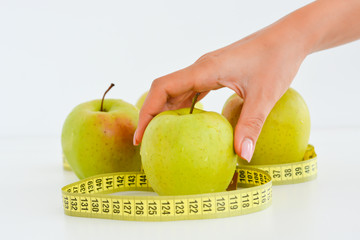 Apple and measuring tape suggesting diet concept