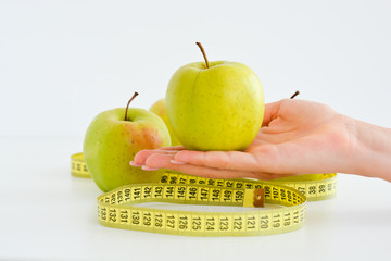 Apple and measuring tape suggesting diet concept
