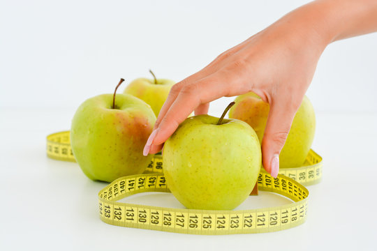 Apple and measuring tape suggesting diet concept