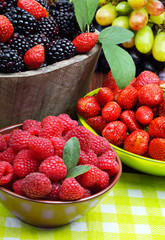 Blackberries, strawberry, raspberry and grapes in a wooden baske