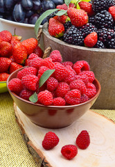 Blackberries, strawberry, raspberry and grapes in a wooden baske