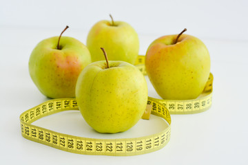 Apple and measuring tape suggesting diet concept