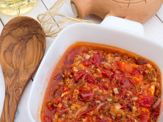 Baked feta cheese with tomatoes, onion, garlic, olive oil and he