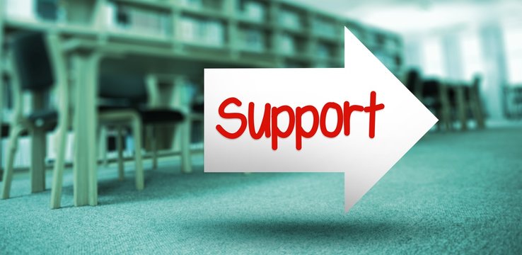Support against volumes of books on bookshelf in library