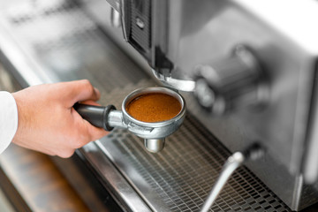 Putting holder to the coffee machine