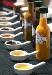Fototapeten Set of delicious home-made chilli sauces in row © kojin_nikon