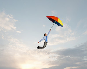 Fototapeta na wymiar Man fly on umbrella