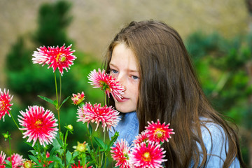 Naklejka premium Teenage schoolgirl portrait with natural flowers