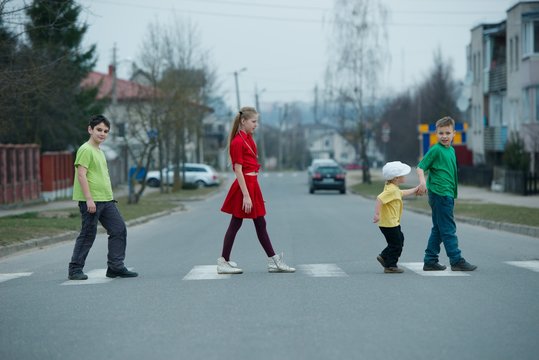 Children Crossing Street On Crosswalk