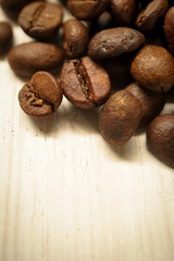coffee beans on white wooden table background
