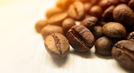 coffee beans on white wooden table background
