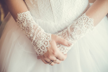 Beautiful bride with hands on white dress