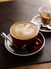 Hot latte on leather plate