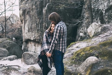 couple in love, walk on the rocks Dovbush Carpathian Mountains